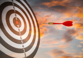 New Target and goal as concept, Close up shot of the dart arrow hit on bullseye, red dart arrow hitting in the target center of dartboard Target hit in the center, challenge in business marketing.